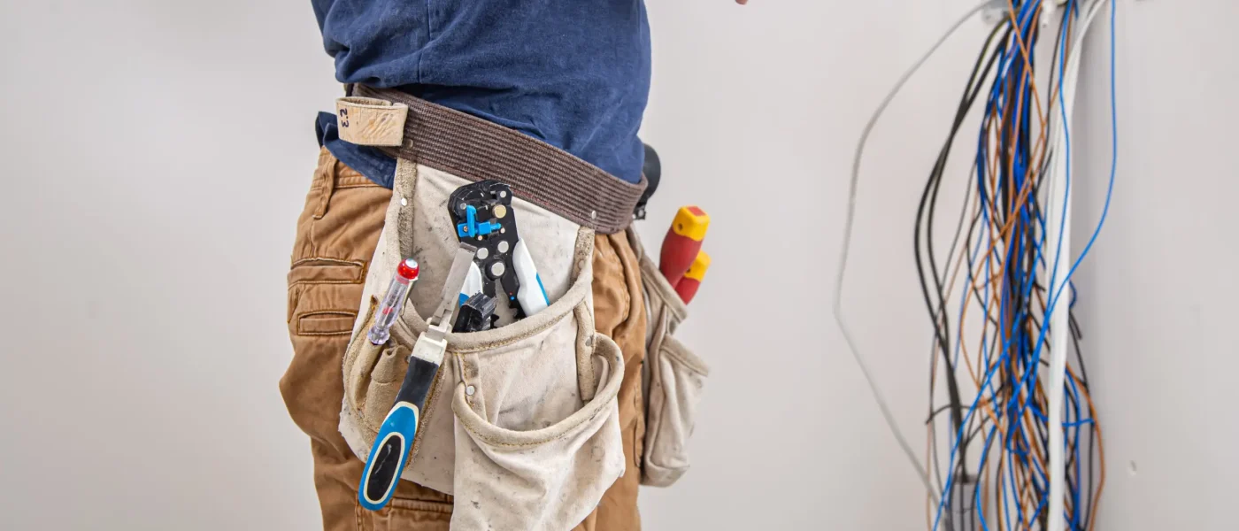 electrician-builder-work-examines-cable-connection-electrical-line-fuselage-industrial-switchboard-professional-overalls-with-electrician-s-tool-scaled
